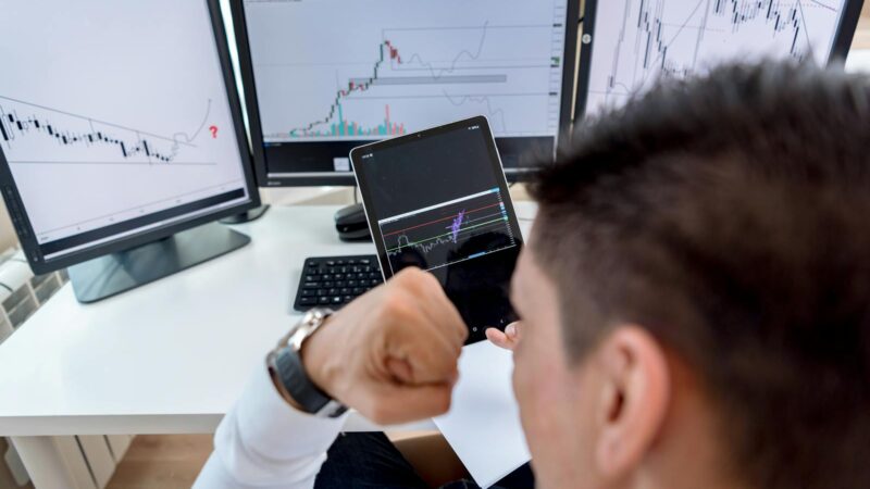 Stock market trader monitoring red declining charts - Gulf markets crisis