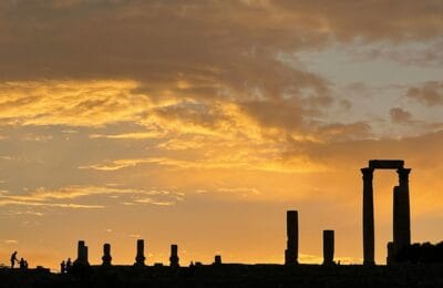 Budget-friendly Middle East travel destination with ancient ruins and dramatic sunset showcasing affordable tourism