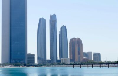 Modern skylines of Dubai, Abu Dhabi, and Riyadh representing the three major Gulf cities compared for cost of living