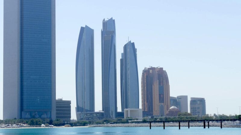 Modern skylines of Dubai, Abu Dhabi, and Riyadh representing the three major Gulf cities compared for cost of living