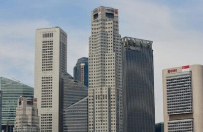 Split view comparing Dubai and Singapore modern skylines representing two global business hubs