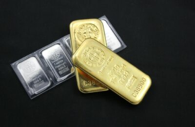 Gold bars and precious metals representing safe haven investment demand