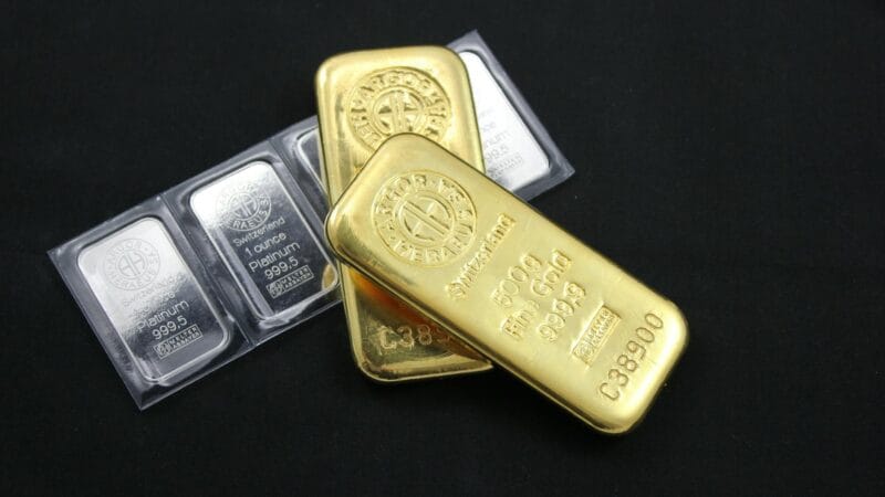 Gold bars and precious metals representing safe haven investment demand