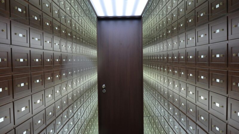 Gold bars stacked in a central bank vault representing the massive institutional demand keeping gold prices elevated despite ceasefire