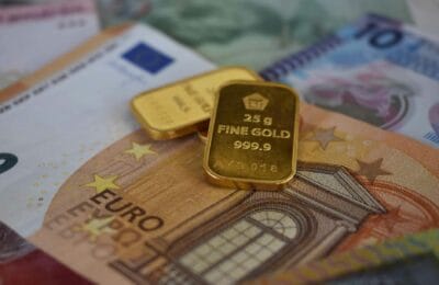 Gold bars and financial instruments representing Middle East investment opportunities in 2026