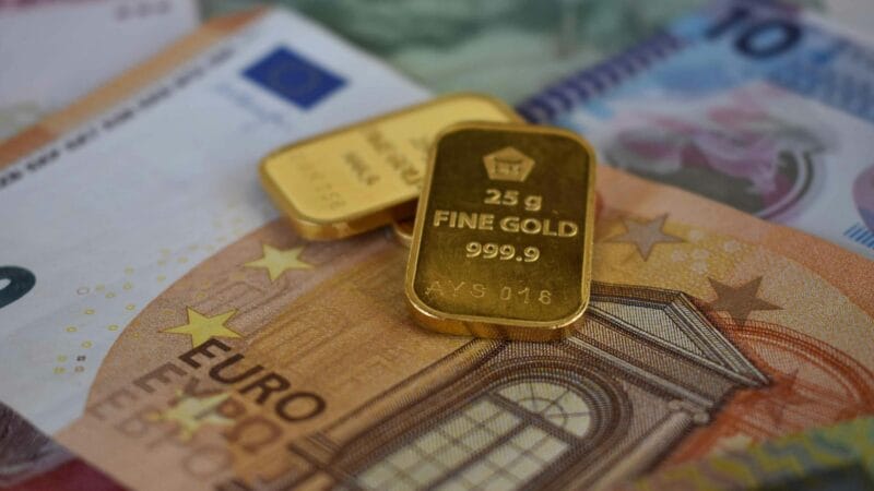Gold bars and financial instruments representing Middle East investment opportunities in 2026