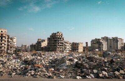 War-torn city with smoke and destruction in the aftermath of military strikes during the 2026 Iran conflict