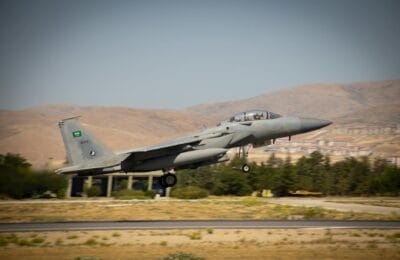 Fighter jet over Middle Eastern terrain representing the week 5 turning point in the 2026 Iran war