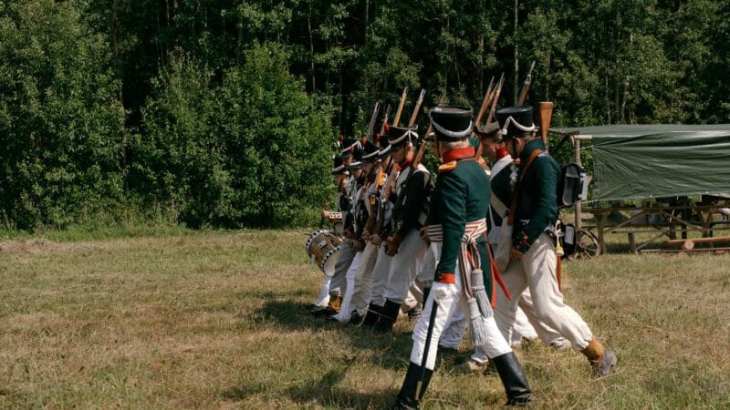 Military field hospital with medical staff treating wounded soldiers and civilians during wartime