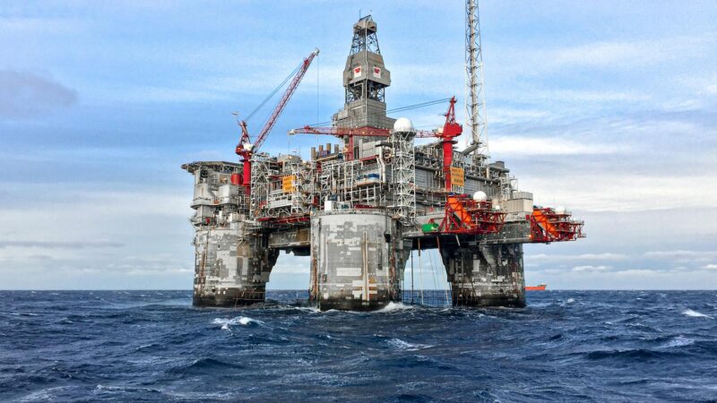 Offshore oil platform in the ocean with dramatic sky reflecting the volatile energy markets of April 2026