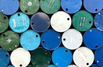 Oil barrels representing Brent crude reaching $100 per barrel milestone in global energy markets