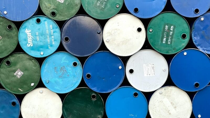 Oil barrels representing Brent crude reaching $100 per barrel milestone in global energy markets