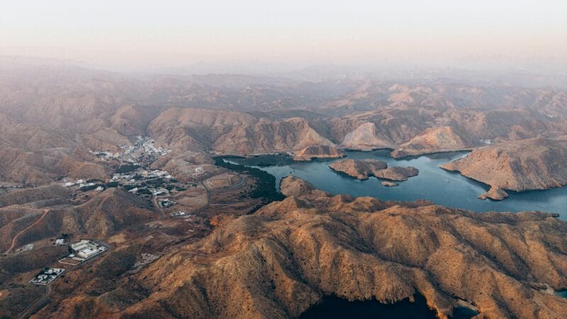 Beautiful coastal landscape of Muscat Oman showing mountains meeting the sea representing the growing appeal of Oman for expats in 2026