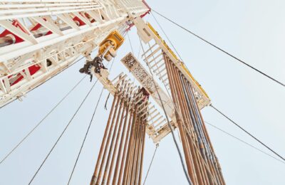 Oil workers at drilling site representing OPEC production decisions