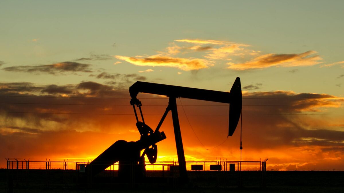 Oil production pump jack in desert landscape