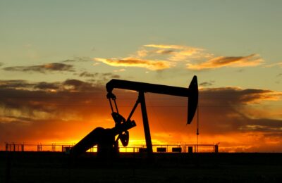 Oil production pump jack in desert landscape