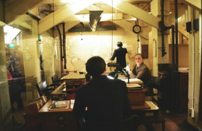 Military command center with multiple screens showing strategic war planning operations