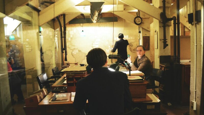 Military command center with multiple screens showing strategic war planning operations