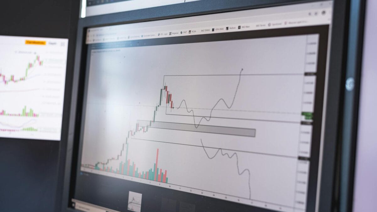 Cairo trading floor with green stock screens and the Nile skyline in the background