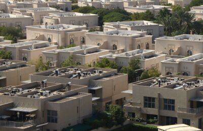 Arab family in a Dubai apartment reviewing grocery receipts and monthly bills