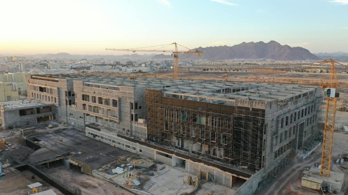 Aerial view of construction cranes and infrastructure in Saudi Arabian desert at NEOM site