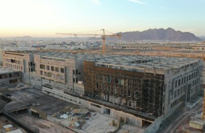Aerial view of construction cranes and infrastructure in Saudi Arabian desert at NEOM site
