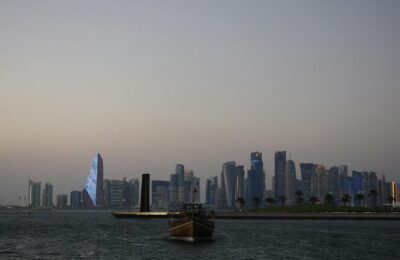 Modern Doha skyline at dusk with West Bay towers and sovereign-wealth-funded infrastructure, illustrating Qatar's position as the richest country in the Middle East in 2026.