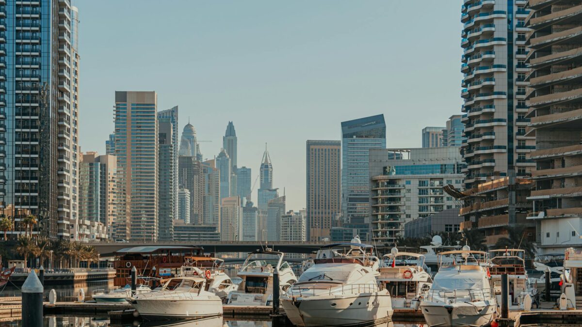 Luxury yachts moored at Dubai Marina at sunset, with skyscrapers in the background, symbolizing the city's extreme concentration of wealth in 2026.