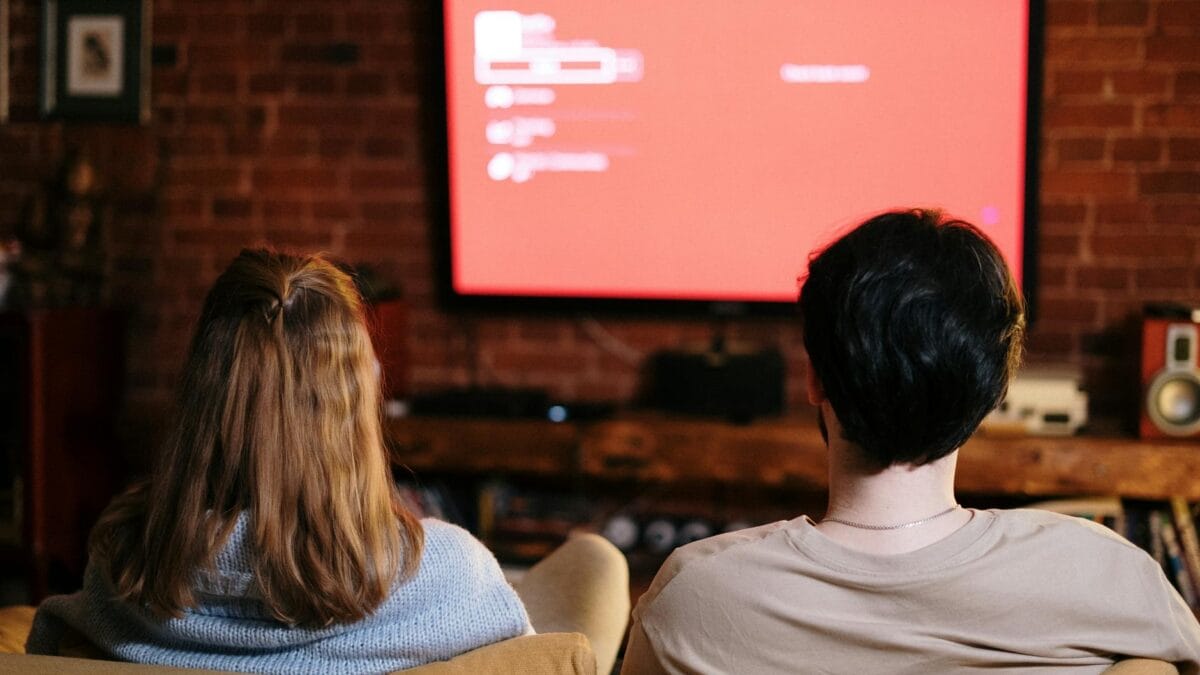 A Middle Eastern family gathered in their living room watching television together in the evening