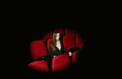 A glamorous Turkish film festival premiere with attendees gathering at a cinema entrance in Istanbul
