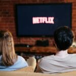 A modern living room with a smart television displaying multiple streaming service options on a cozy evening